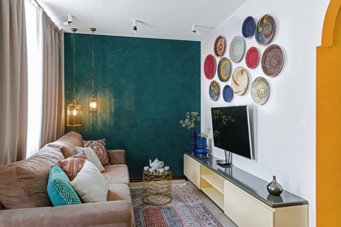 TV on the wall with a decorative panel in the hall