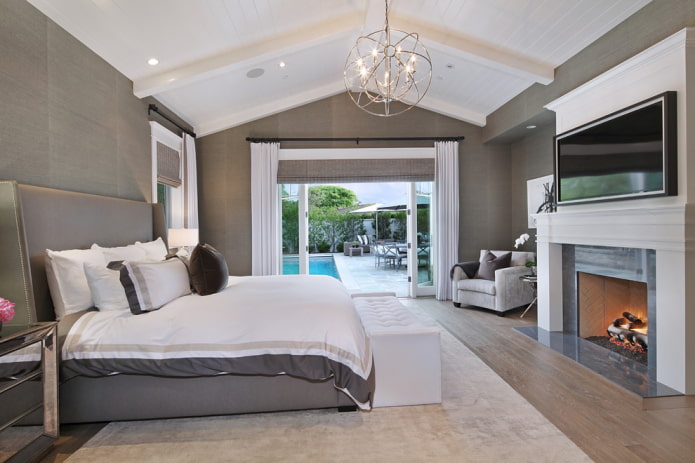 TV in the interior of the bedroom with a fireplace