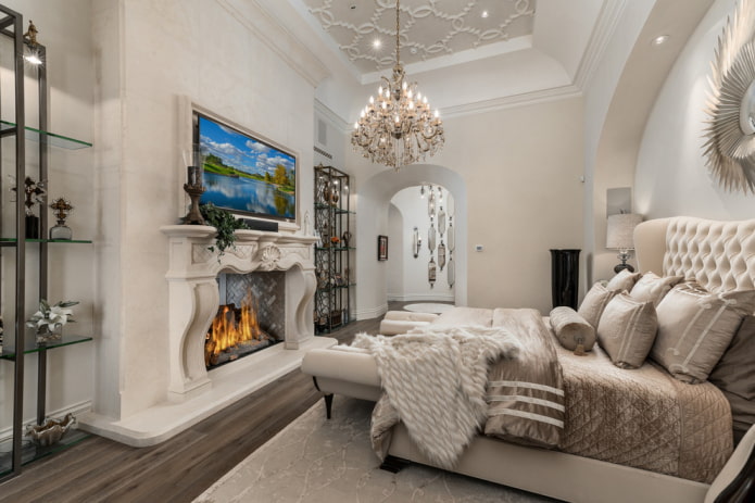 TV in the interior of the bedroom with a fireplace