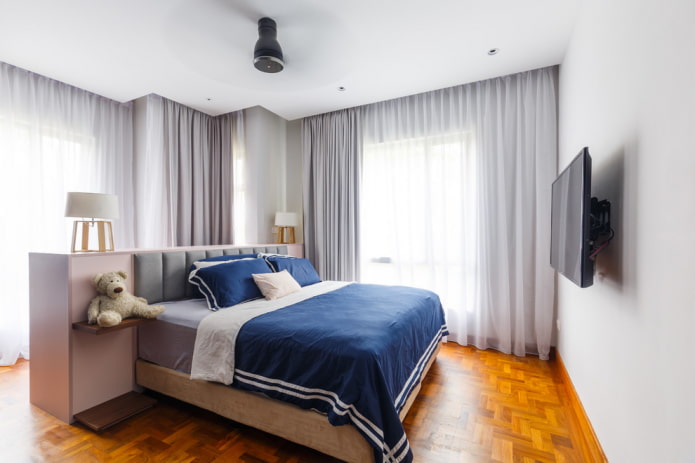 TV on a bracket in the bedroom interior