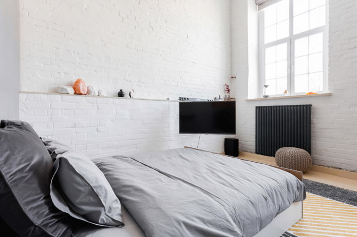 TV in the interior of the bedroom in the loft style