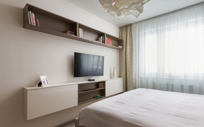 TV on the wall with shelves in the bedroom interior