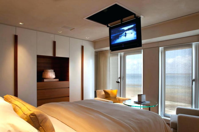 TV on the ceiling in the bedroom interior