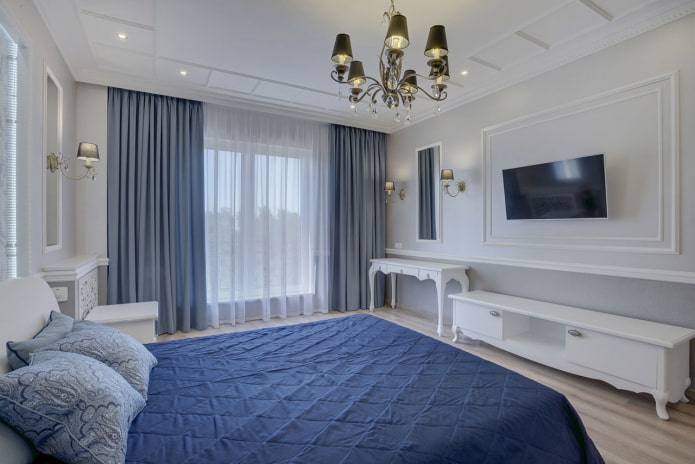 TV on the wall with moldings in the bedroom