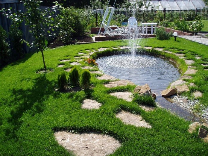 artificial pond with a fountain in the country
