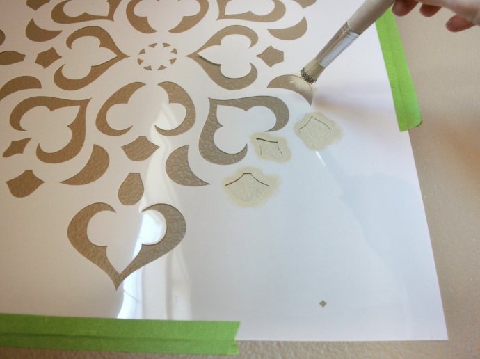 applying paint to the wall