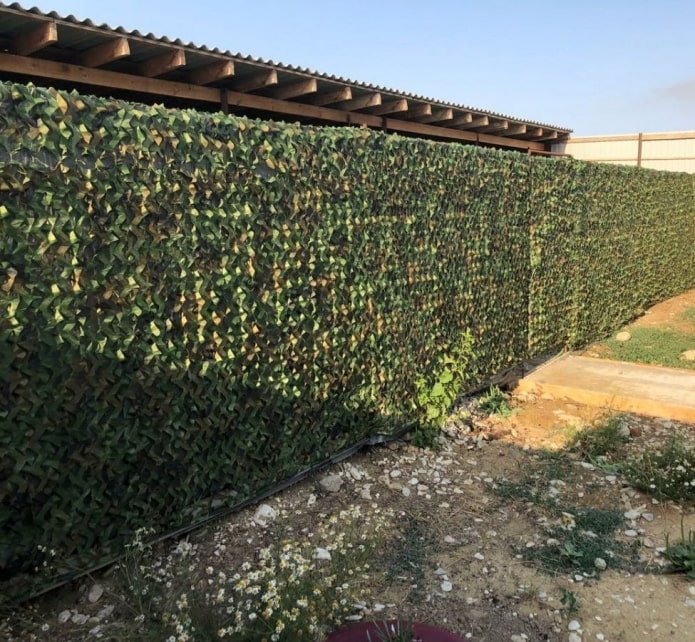 camouflage net on chain-link fencing