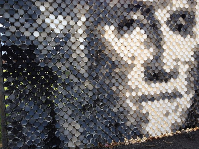 picture of cups in a chain-link fence