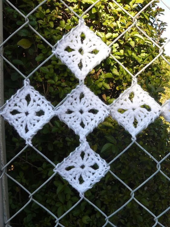 cross stitch on a chain-link fence