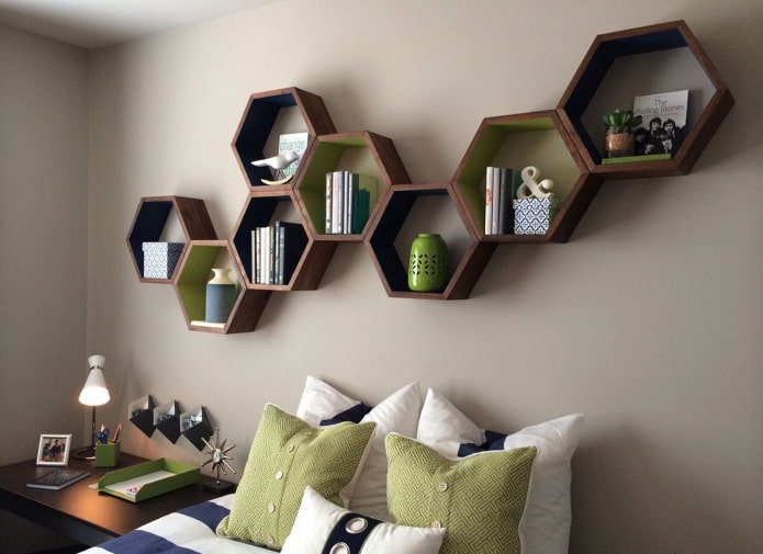 a honeycomb-shaped bookshelf above the bed