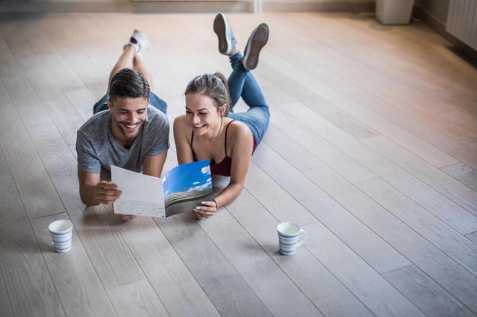 man and woman looking at a catalog