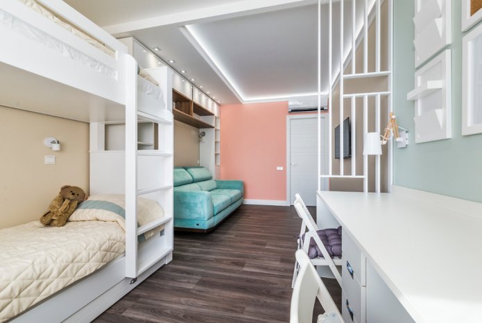 narrow children's room with a sofa and two beds
