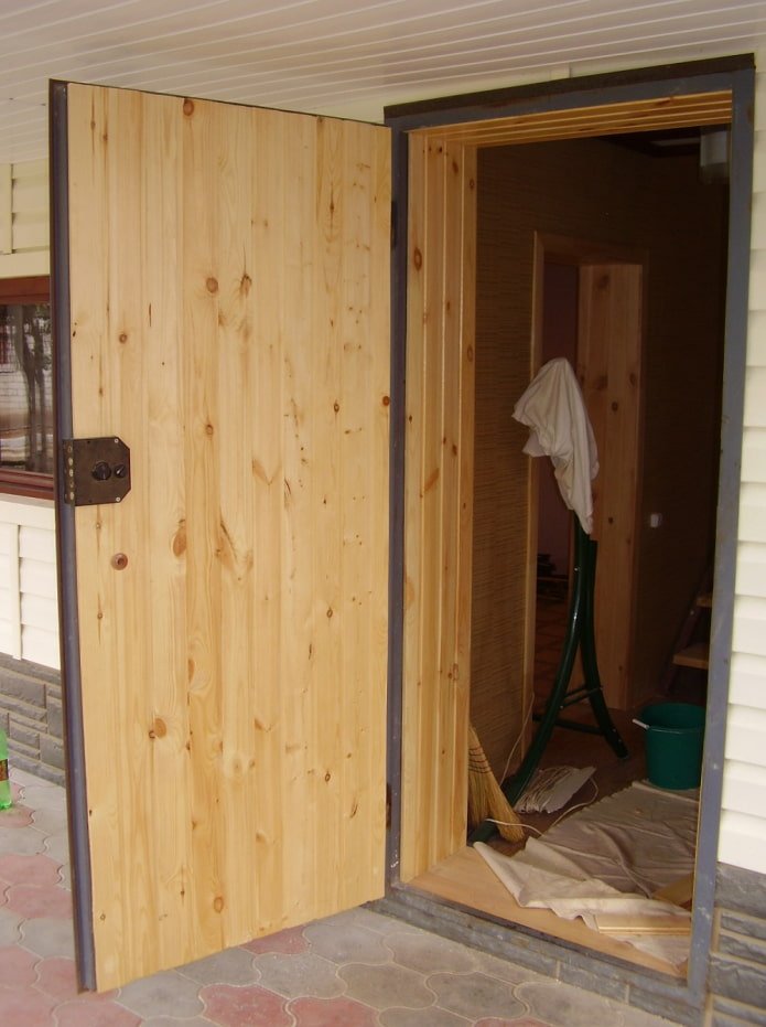 Entrance door made of clapboard