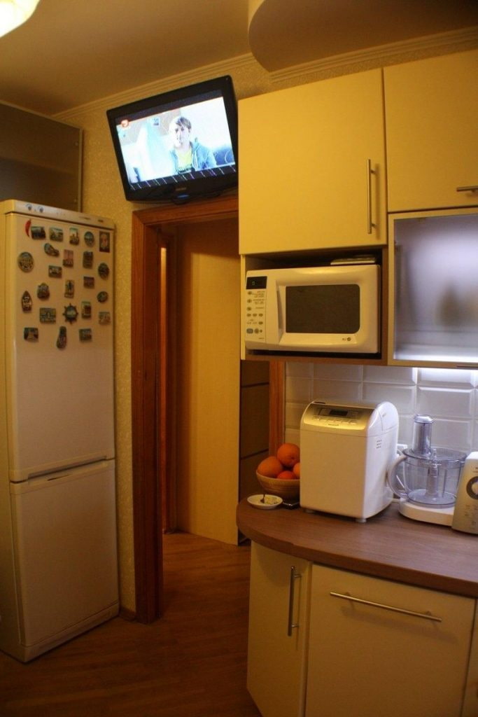 TV above the door in the kitchen