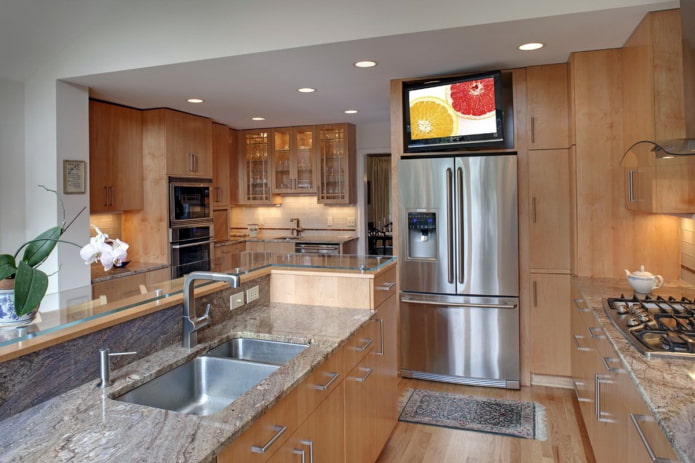 TV above the refrigerator in the kitchen