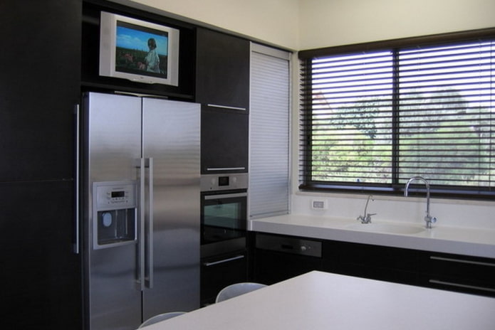 TV above the refrigerator in the kitchen