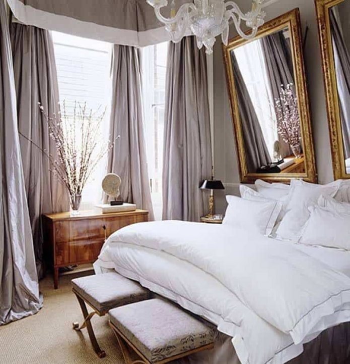 Mirrors in a carved frame above the bed