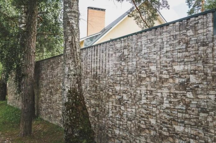 Fence made of corrugated sheet under the stone