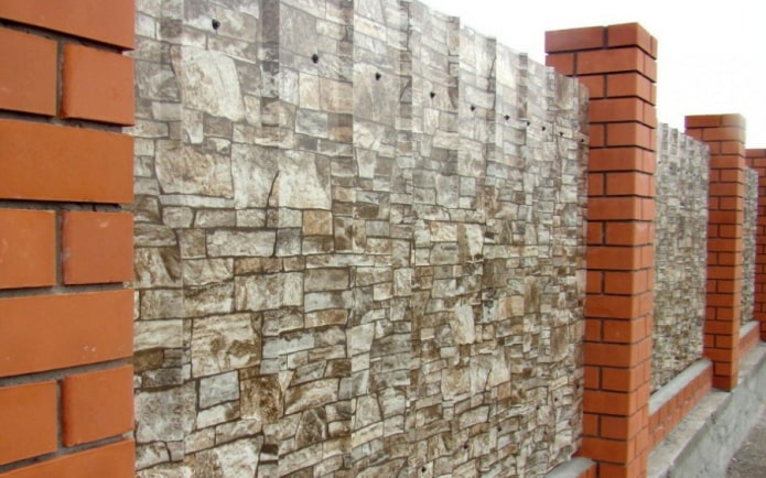 Fence made of corrugated sheets with brick columns