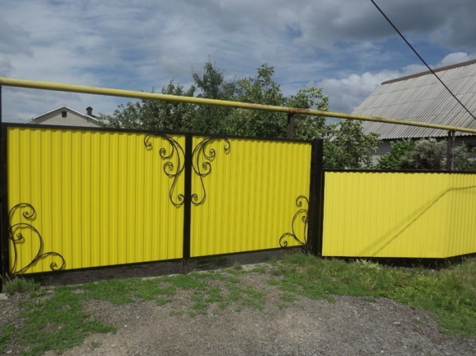 Yellow fence made of corrugated sheet