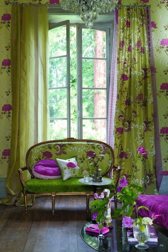 sofa with green upholstery with flowers in the interior