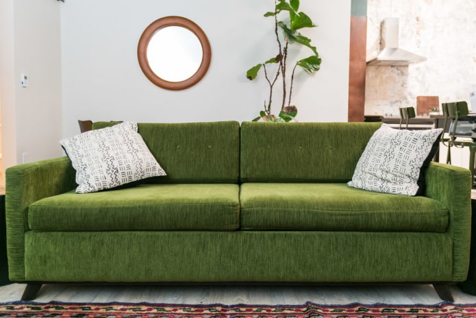 sofa with green fabric upholstery in the interior