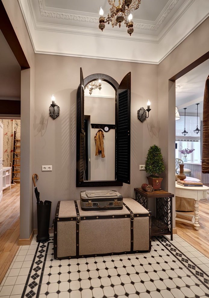 mirror with sconces in the interior of the hallway