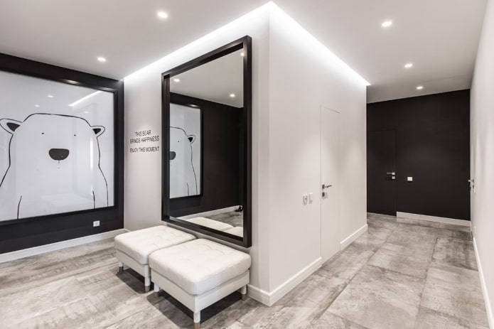 mirror in a black frame in the interior of the hallway