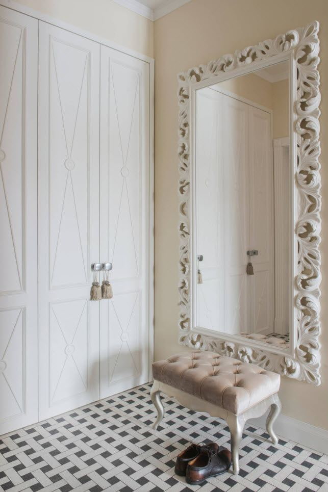 mirror in a white frame in the interior of the hallway