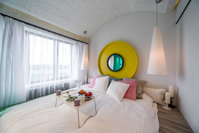 mirror above the bed in the bedroom interior