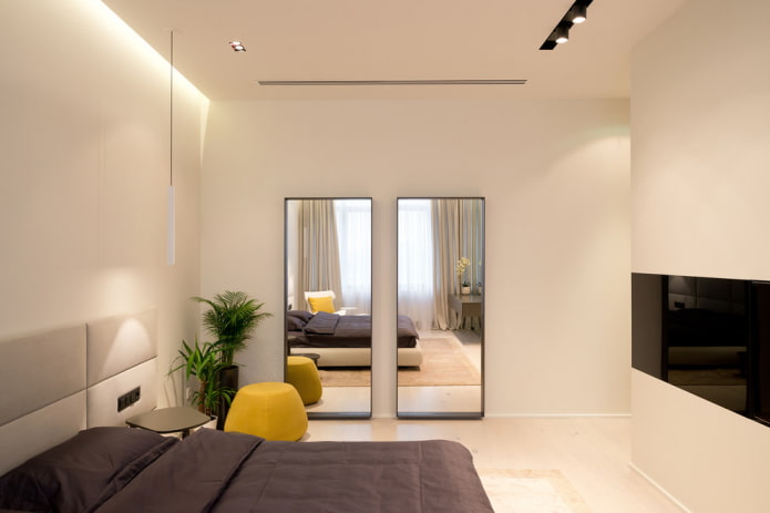 mirror opposite the window in the bedroom interior