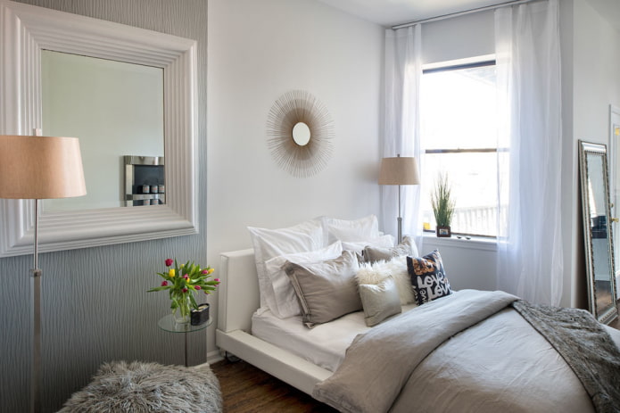 mirror in a white frame in the bedroom interior