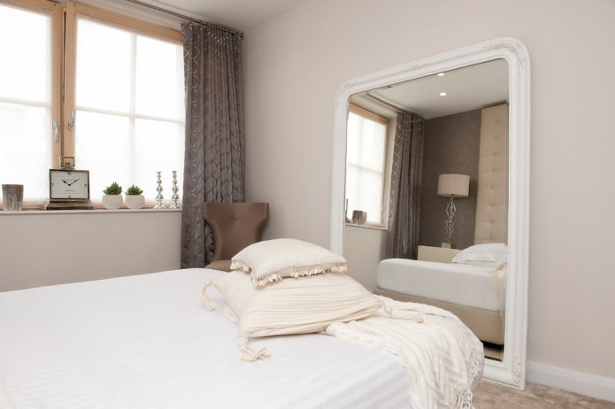mirror in a white frame in the bedroom interior
