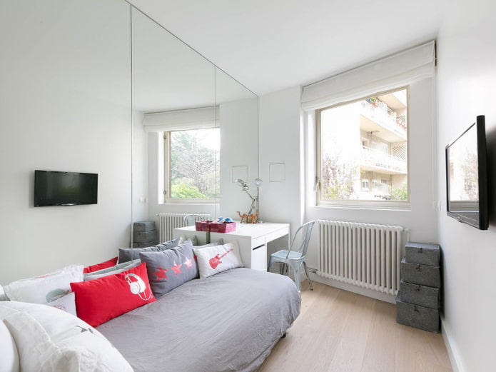 mirror on the entire wall in the bedroom interior