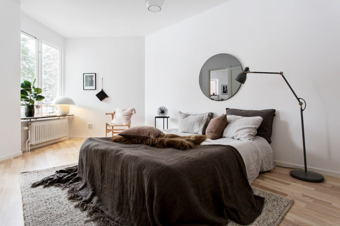 round mirror in the bedroom interior