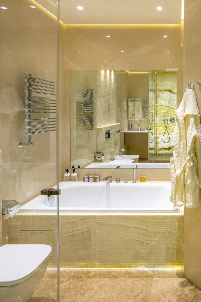 mirror above the bathtub in the bathroom interior
