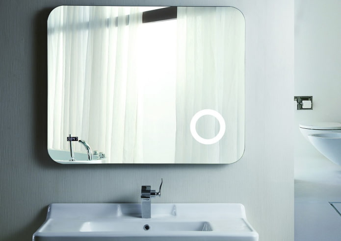 mirror with a clock in the bathroom interior