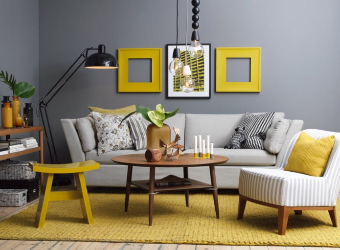 yellow paintings and a carpet in a living room with gray walls
