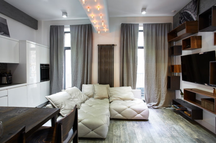 zoning with lighting in the interior of the kitchen-living room